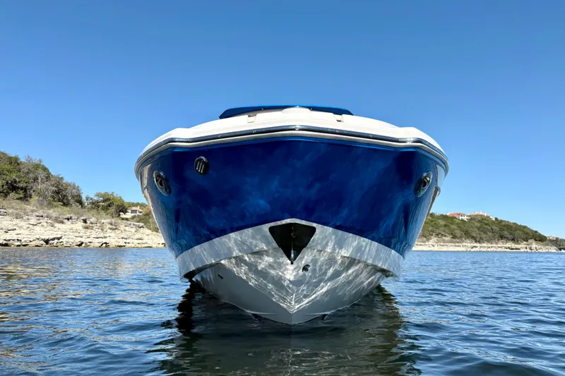 Slide: The Image of 2017 Chaparral 246 SSi boat on calm water, clear blue sky background. - 8