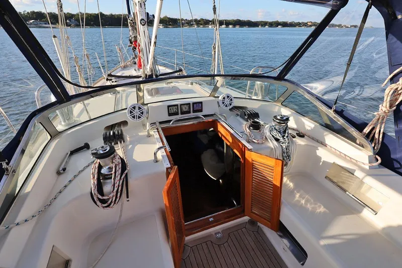 Slide: The Image of Center cockpit of 2009 Passport Vista 515 sailboat with open hatch and nautical equipment. - 10