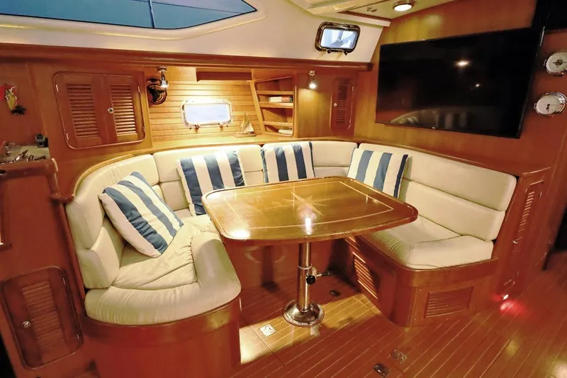 Slide: The Image of Luxurious interior of 2009 Passport Vista 515 Center Cockpit yacht with cozy seating and table. - 13