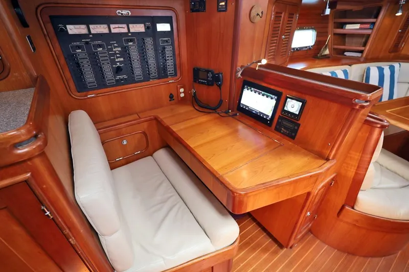 Slide: The Image of Navigation station in 2009 Passport Vista 515 Center Cockpit yacht with control panel and seating. - 14