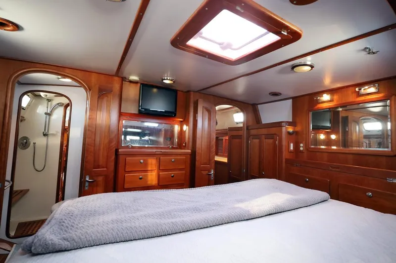 Slide: The Image of Luxurious interior of 2009 Passport Vista 515 Center Cockpit yacht with wood finish and cozy bed. - 19
