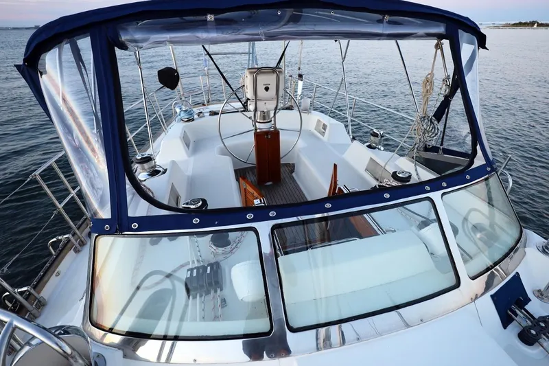Slide: The Image of Center cockpit of 2009 Passport Vista 515 sailboat with clear canopy and steering wheel. - 2
