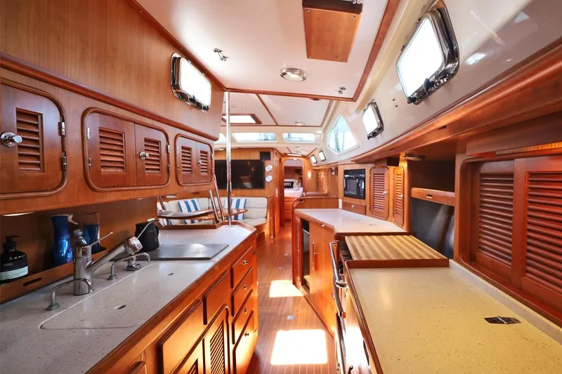 Slide: The Image of Luxurious interior of 2009 Passport Vista 515 Center Cockpit yacht with wooden cabinetry. - 21