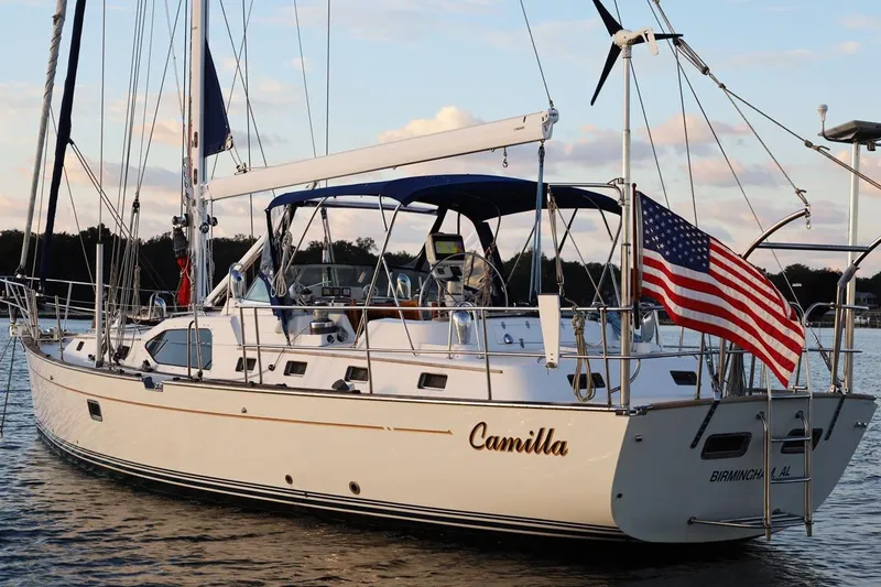 Slide: The Image of 2009 Passport Vista 515 Center Cockpit sailboat with American flag, named "Camilla." - 4