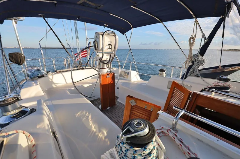 Slide: The Image of 2009 Passport Vista 515 Center Cockpit sailboat with ocean view and American flag. - 7
