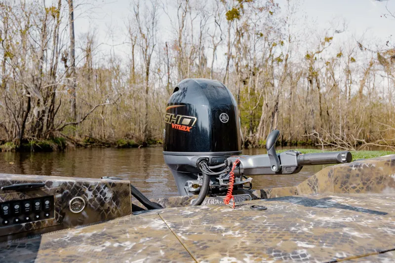 Slide: The Image of 2026 Excel 183 Tomahawk boat with Yamaha SHO VMAX engine in a wooded waterway. - 19