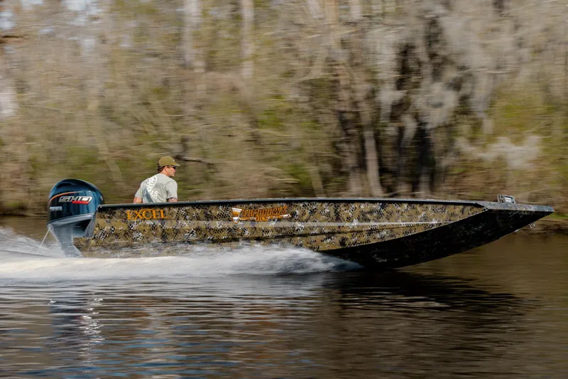 Slide: The Image of Speeding Excel 183 Tomahawk boat on water, 2026 model, with camo design and powerful engine. - 2