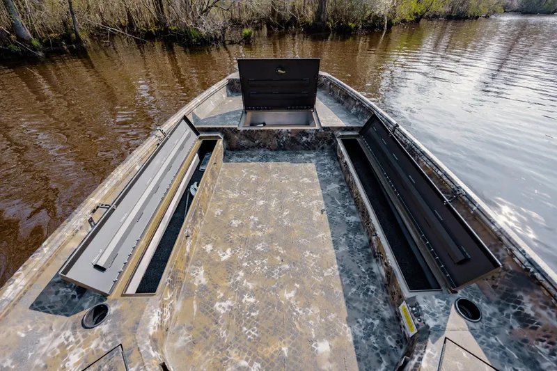 Slide: The Image of 2026 Excel 183 Tomahawk boat interior with open storage compartments on a calm river. - 20