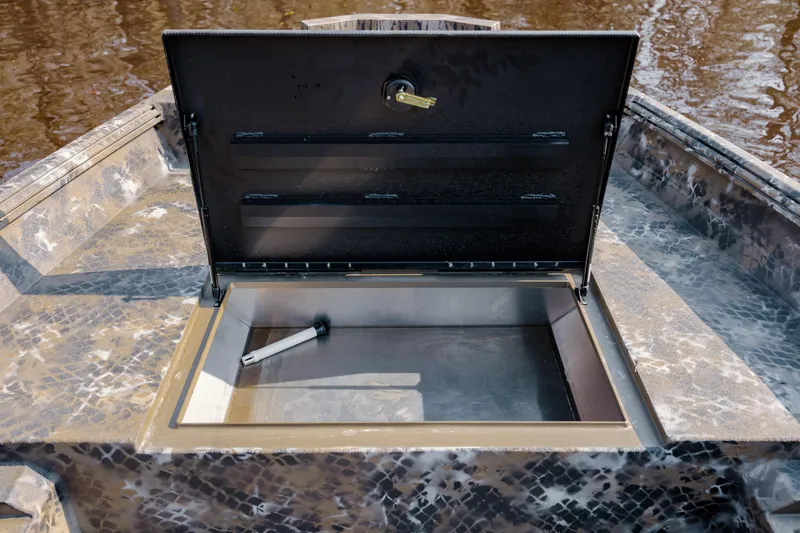 Slide: The Image of Open storage compartment on 2026 Excel 183 Tomahawk boat, featuring camouflage design. - 21