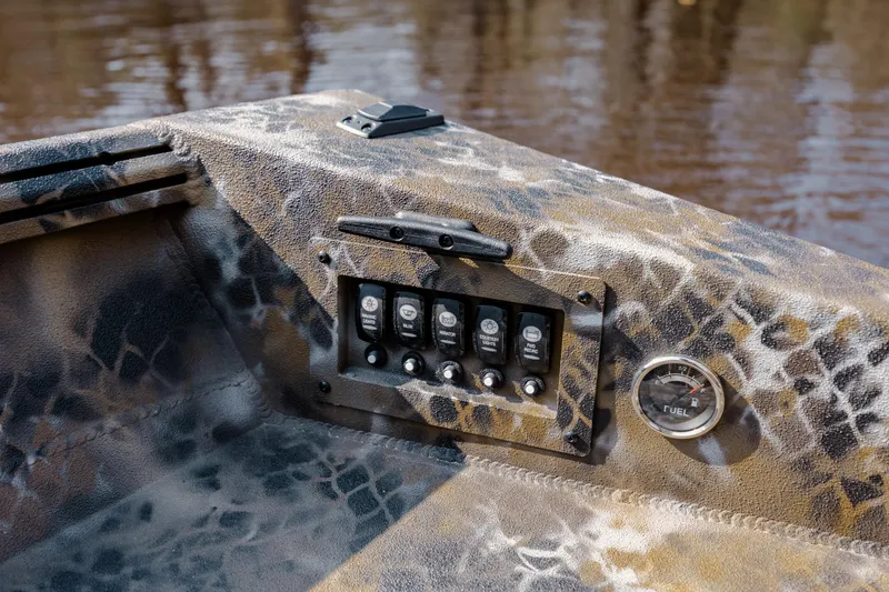 Slide: The Image of Control panel of 2026 Excel 183 Tomahawk boat with camouflage design and fuel gauge. - 23