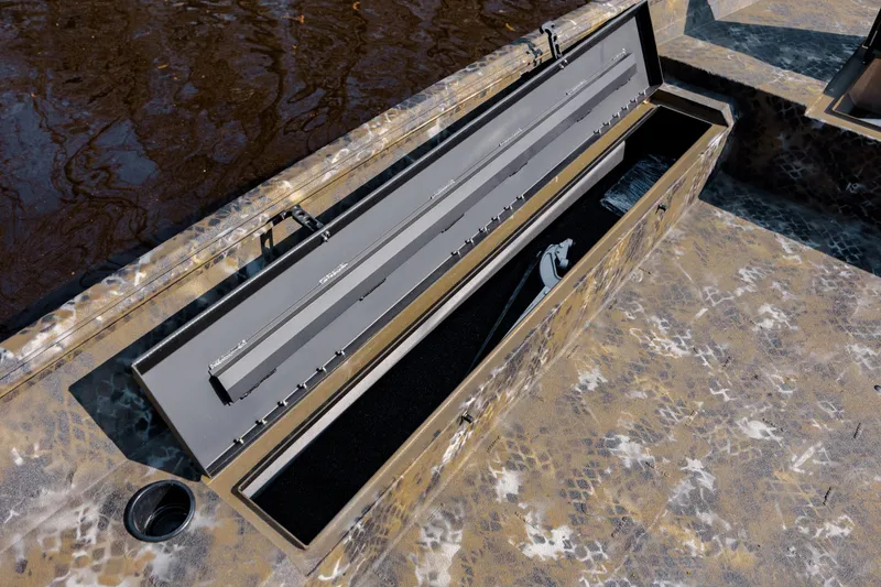 Slide: The Image of Open storage compartment on 2026 Excel 183 Tomahawk boat with camouflage design. - 24