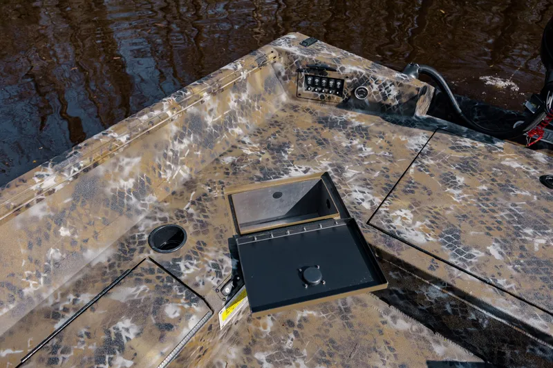 Slide: The Image of Camouflage-patterned deck of 2026 Excel 183 Tomahawk boat with storage compartments. - 26