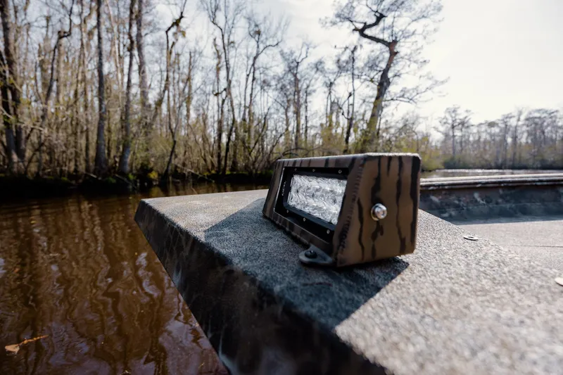 Slide: The Image of Boat deck with mounted light, surrounded by trees and water, Excel 183 Tomahawk 2026 model. - 27