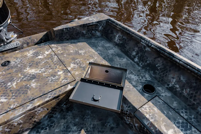 Slide: The Image of Camouflage-patterned deck of 2026 Excel 183 Tomahawk boat with storage compartment open. - 28