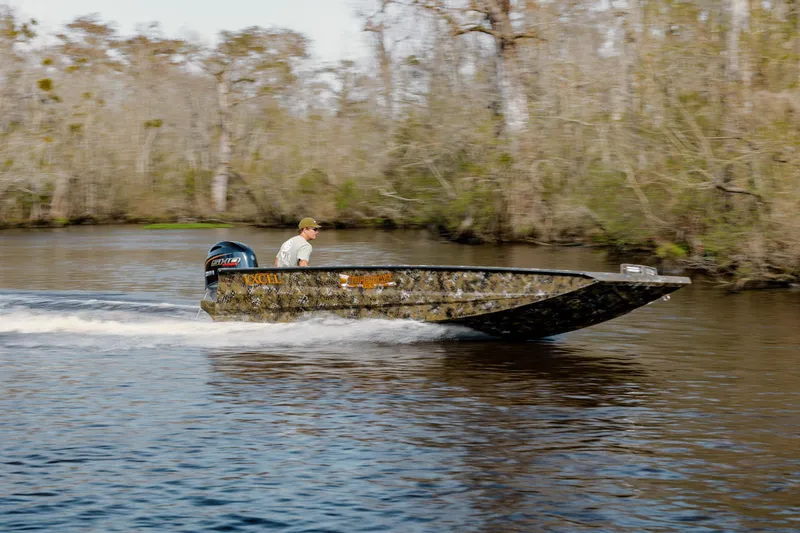 Slide: The Image of Man driving 2026 Excel 183 Tomahawk boat on a calm river. - 3
