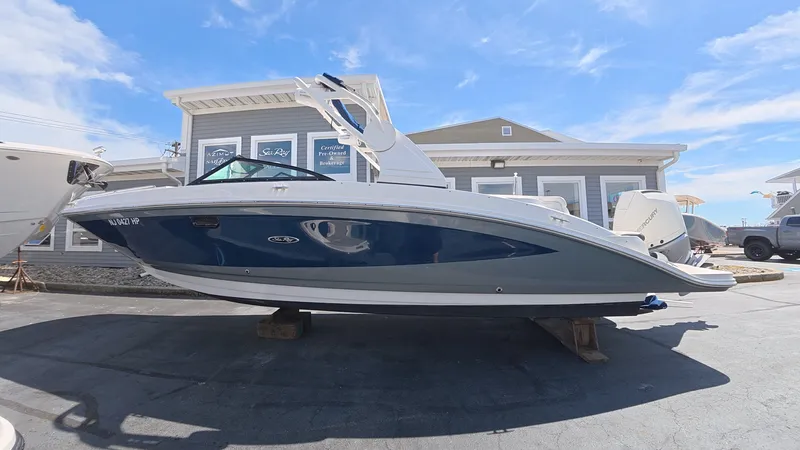 Slide: The Image of 2020 Sea Ray SDX 270 Outboard boat on a parking lot. - 0