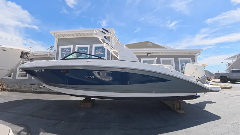 Slide: The Image of 2020 Sea Ray SDX 270 Outboard boat in front of a building. - 1