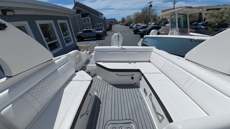Slide: The Image of Interior view of a 2020 Sea Ray SDX 270 Outboard boat with white seating. - 10