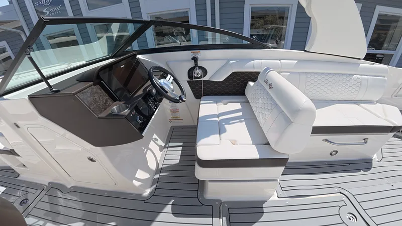 Slide: The Image of Interior of a 2020 Sea Ray SDX 270 Outboard boat with white seating area. - 18
