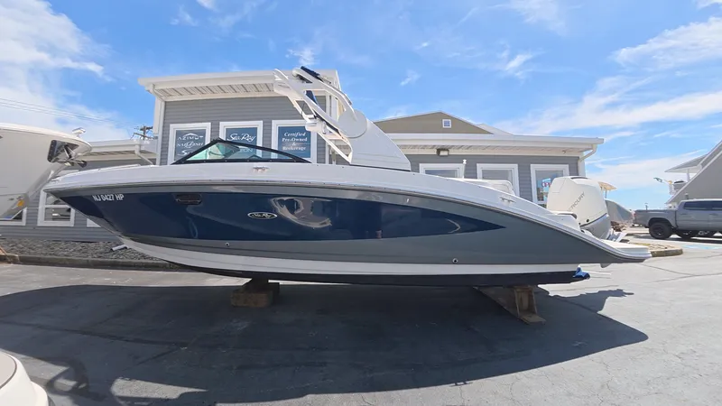 Slide: The Image of 2020 Sea Ray SDX 270 Outboard boat on a parking lot. - 2