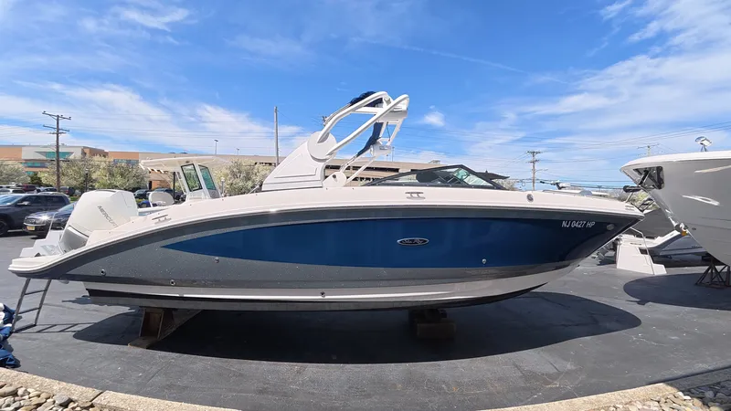 Slide: The Image of 2020 Sea Ray SDX 270 Outboard boat on a parking lot. - 3