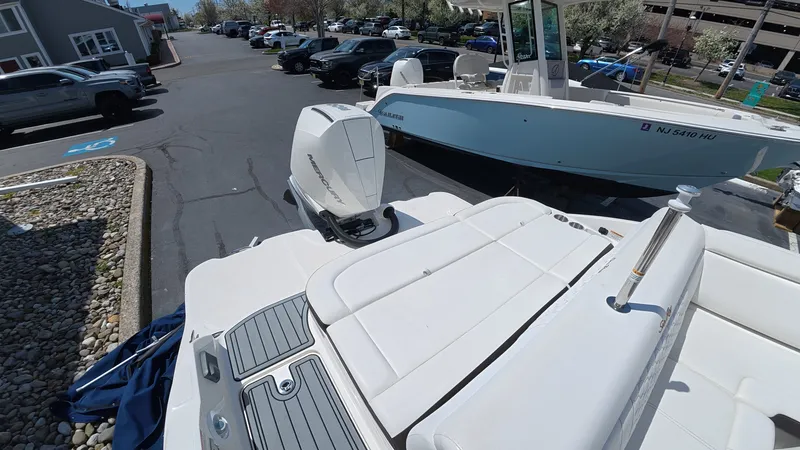 Slide: The Image of 2020 Sea Ray SDX 270 Outboard on a parking lot. - 7