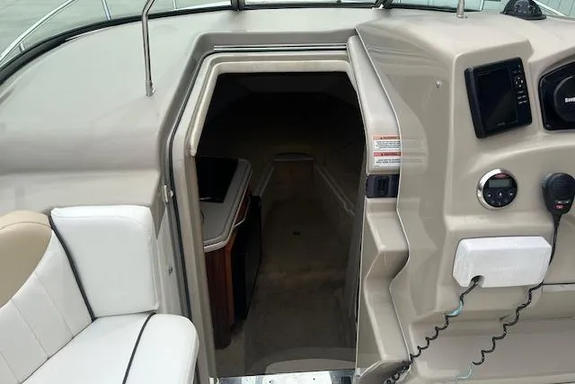 Slide: The Image of 2008 Sea Ray 240 Sundancer cabin entrance with dashboard and seating area. - 11