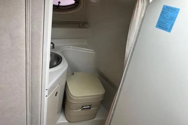 Slide: The Image of Compact bathroom in 2008 Sea Ray 240 Sundancer boat with sink and portable toilet. - 16