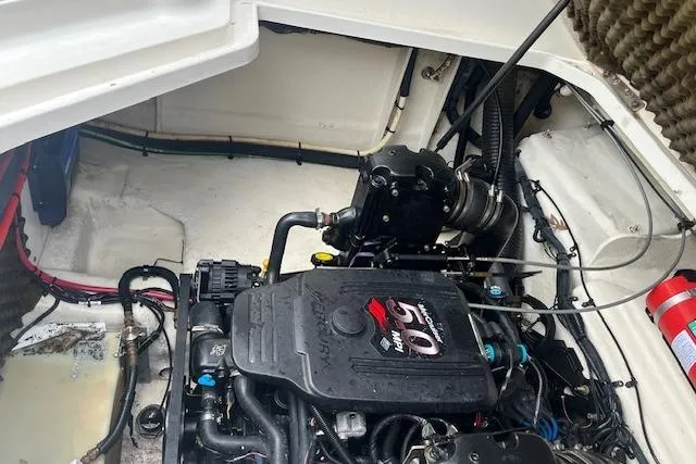 Slide: The Image of Engine compartment of a 2008 Sea Ray 240 Sundancer boat, featuring a well-maintained motor. - 22
