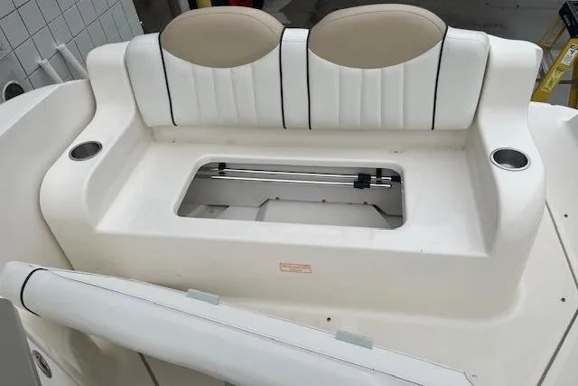 Slide: The Image of 2008 Sea Ray 240 Sundancer boat seating area with storage compartment. - 24