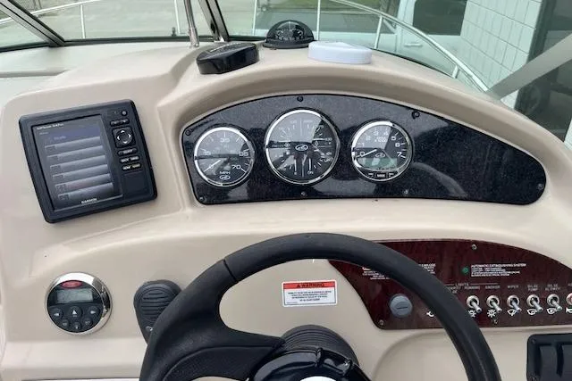 Slide: The Image of Dashboard of a 2008 Sea Ray 240 Sundancer boat with gauges and controls. - 25