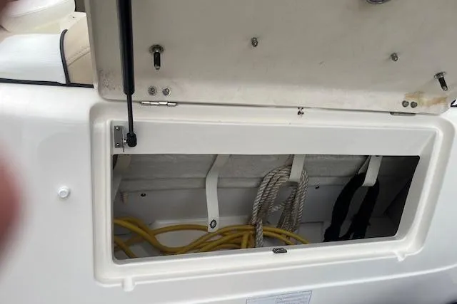 Slide: The Image of Storage compartment on a 2008 Sea Ray 240 Sundancer boat with ropes and cables. - 4