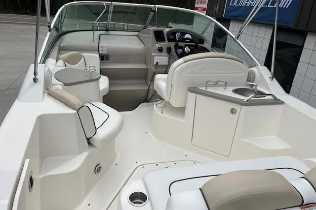 Slide: The Image of 2008 Sea Ray 240 Sundancer boat interior with seating and helm, showcasing modern design. - 5