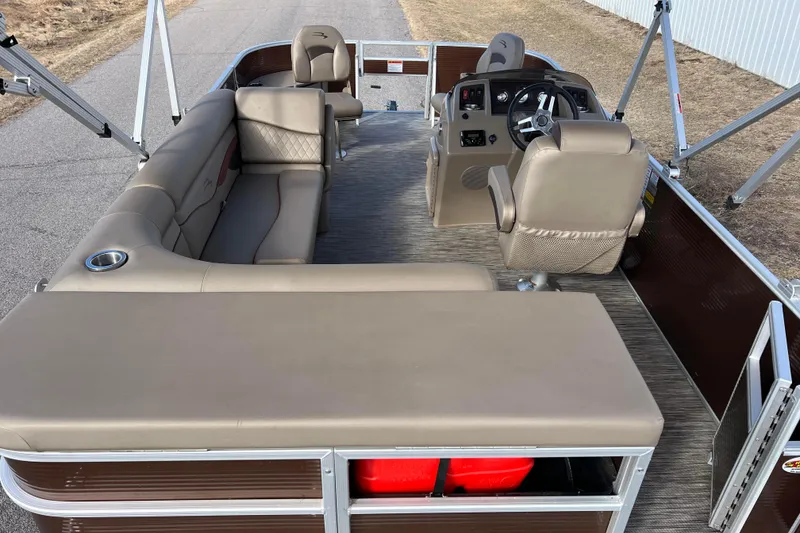Slide: The Image of 2021 Bennington 168 FISH CRUISE pontoon boat interior with beige seating and steering console. - 2