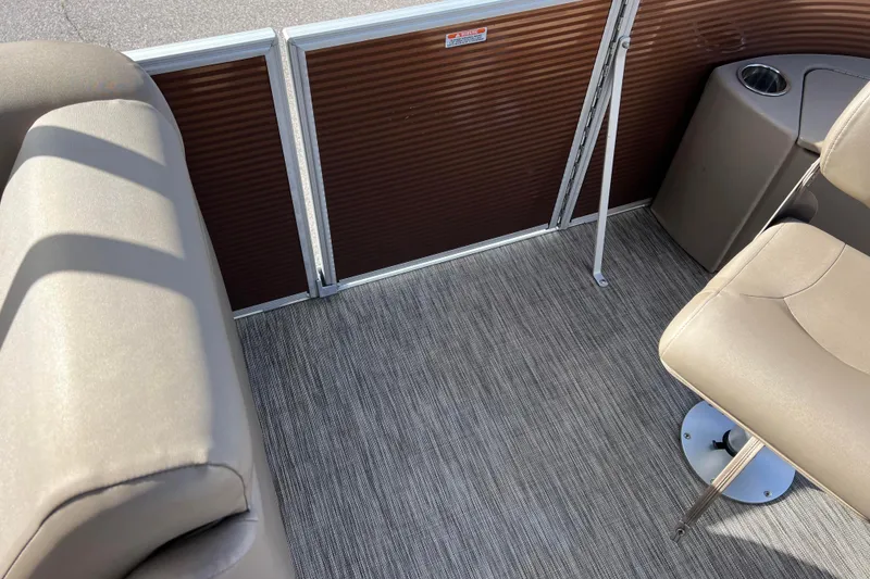 Slide: The Image of Interior of 2021 Bennington 168 FISH CRUISE boat with beige seating and carpeted floor. - 29