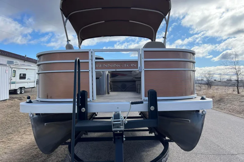 Slide: The Image of 2021 Bennington 168 Fish Cruise pontoon boat on trailer under cloudy sky. - 4