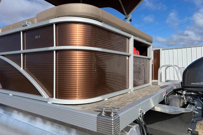 Slide: The Image of 2021 Bennington 168 FISH CRUISE pontoon boat with brown paneling and outboard motor. - 42
