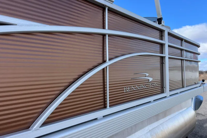 Slide: The Image of 2021 Bennington 168 Fish Cruise pontoon boat with brown paneling and logo. - 48