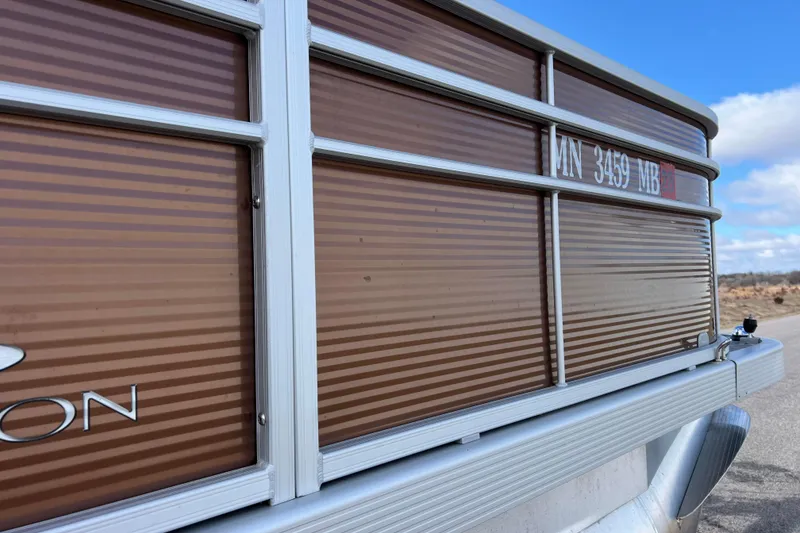 Slide: The Image of 2021 Bennington 168 Fish Cruise boat with brown paneling and registration number. - 49