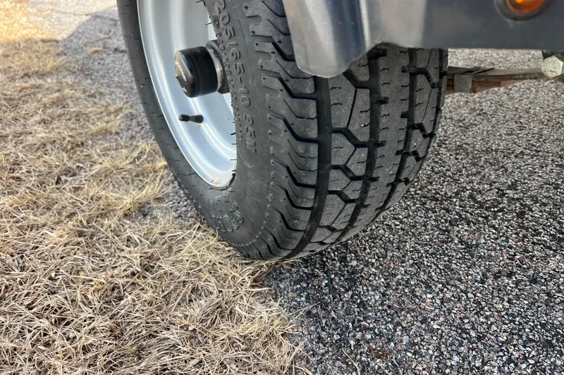 Slide: The Image of Close-up of a 2021 Bennington 168 FISH CRUISE trailer tire on grass and pavement. - 54