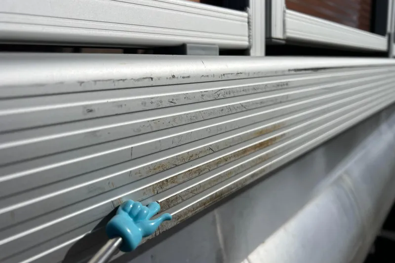Slide: The Image of Close-up of 2021 Bennington 168 Fish Cruise aluminum siding with a blue cleaning tool. - 56