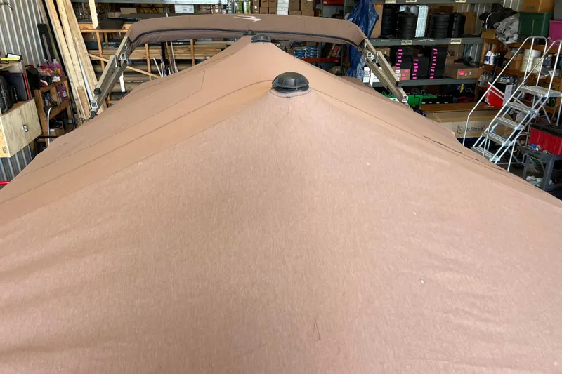 Slide: The Image of 2021 Bennington 168 FISH CRUISE boat with brown cover in storage. - 59