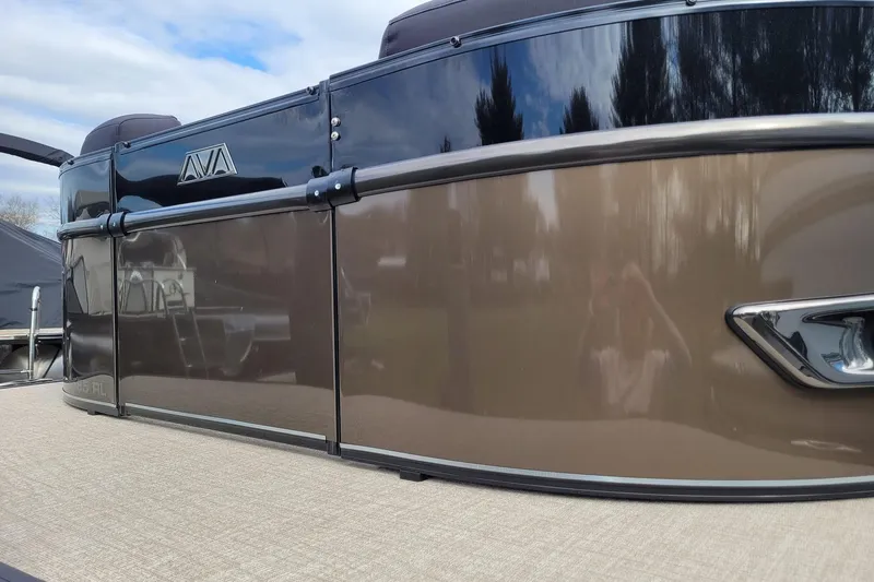 The Image of 2024 Avalon Catalina 2585 RL pontoon boat with sleek brown exterior design. - 0