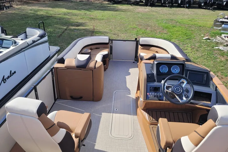 Slide: The Image of 2024 Avalon Catalina 2585 RL boat interior with luxurious seating and modern dashboard. - 6