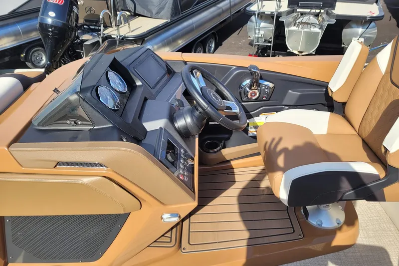 Slide: The Image of 2024 Avalon Catalina 2585 RL boat cockpit with steering wheel and control panel. - 7