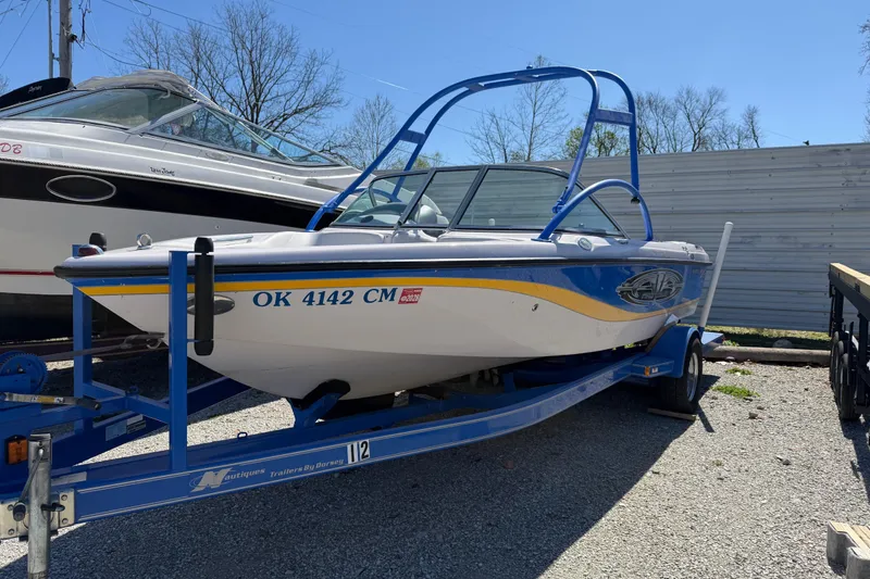 Slide: The Image of 2004 Nautique Super Air Nautique 210 boat on trailer, parked outdoors. - 11