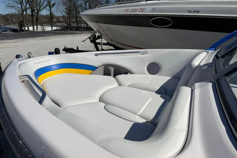 Slide: The Image of 2004 Nautique Super Air Nautique 210 boat interior with white and blue-yellow accents. - 13