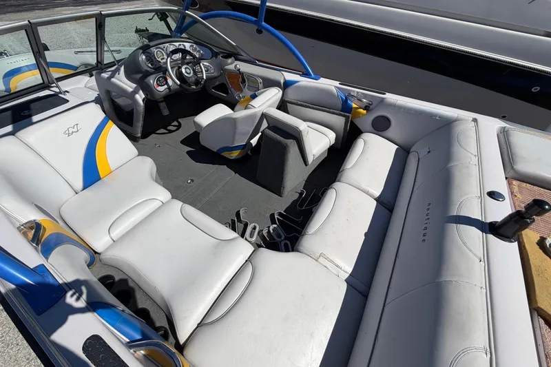 Slide: The Image of 2004 Nautique Super Air Nautique 210 boat interior with white and blue seating. - 14
