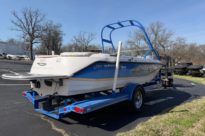 Slide: The Image of 2004 Nautique Super Air Nautique 210 boat on trailer in parking lot. - 5