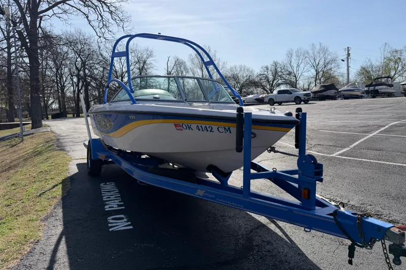 Slide: The Image of 2004 Nautique Super Air Nautique 210 boat on trailer in parking lot. - 7